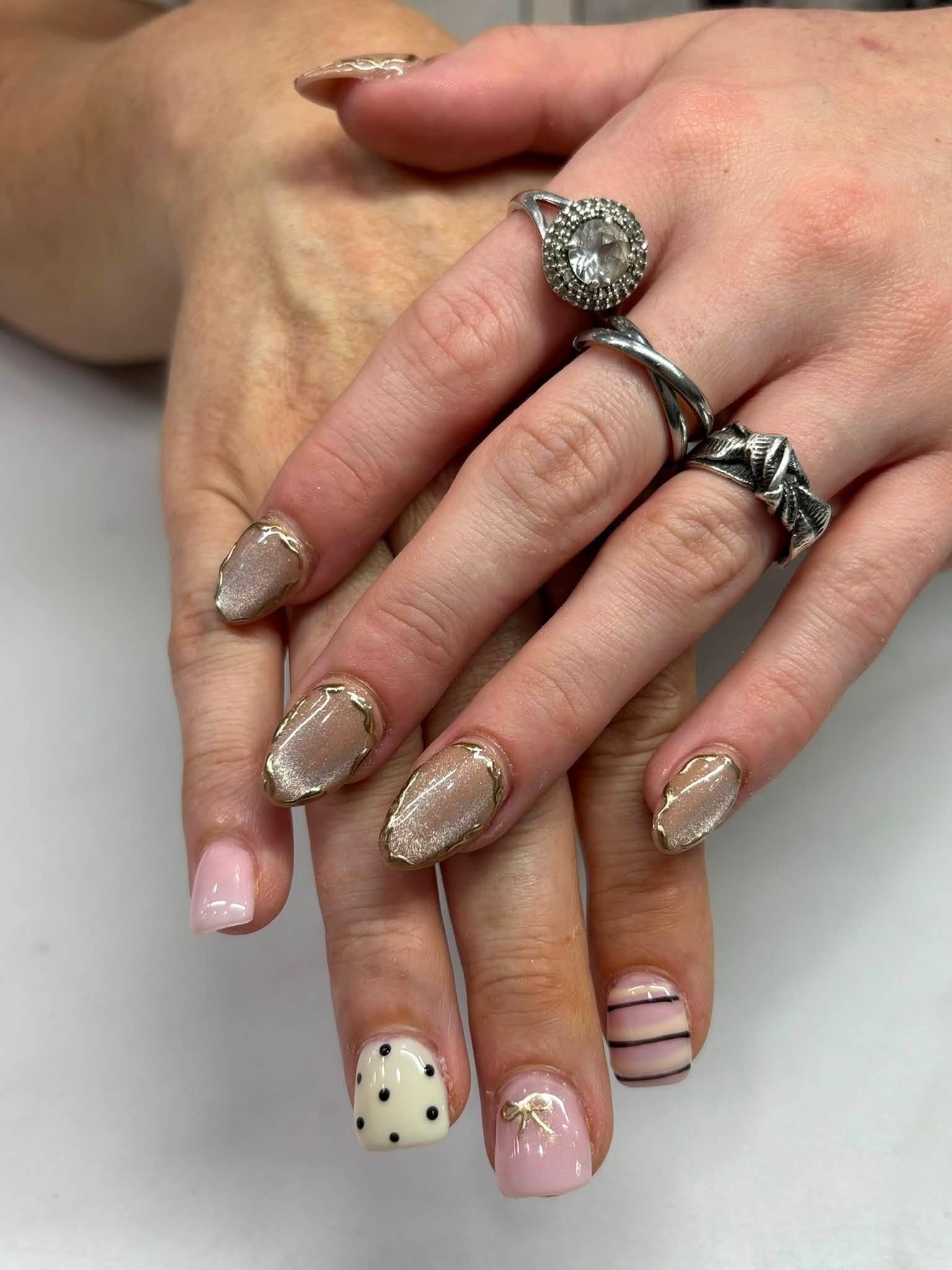 Chrome manicure paired with soft polka-dot nail art