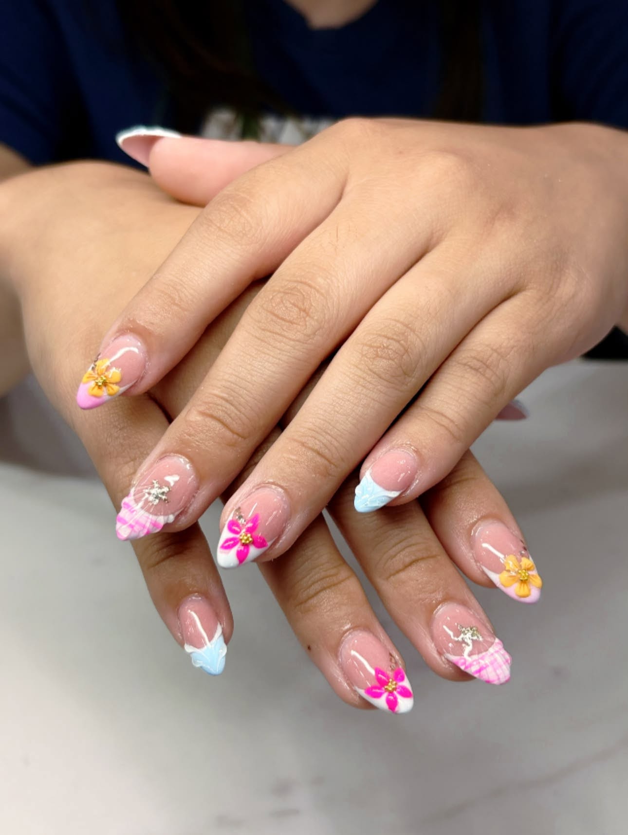 Floral French manicure created at Creative Nails & Spa